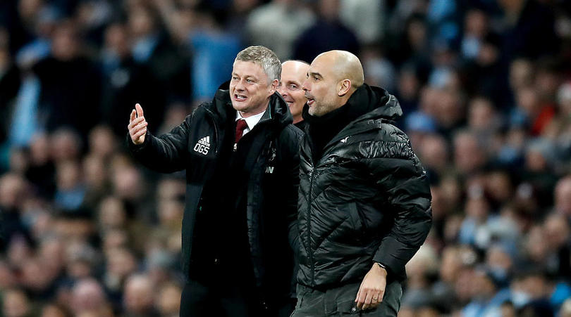 Manchester United manager Ole Gunnar Solskjaer (left) and Manchester City manager Pep Guardiola (right) enjoy a laugh on the touchline during the Premier League match at the Etihad Stadium, Manchester.