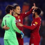 Liverpool's Virgil van Dijk, Joe Gomez (right) and goalkeeper Alisson (left) celebrate after the match