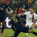 PSG's Mauro Icardi, right, is tackled by Real Madrid's Raphael Varane during a Champions League match