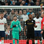 Manchester City's Raheem Sterling is booked for a challenge on Tottenham Hotspur's Dele Alli during the Premier League match at Tottenham Hotspur Stadium, London.