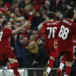 Liverpool players celebrate after Shrewsbury Town's Ro-Shaun Williams, scored an own goal during the FA Cup fourth round replay match at Anfield, Liverpool.