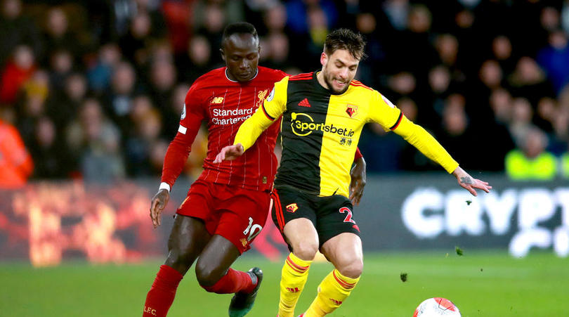 Liverpool's Sadio Mane and Watford's Kiko Femenia battle for the ball during the Premier League match at Vicarage Road, Watford.