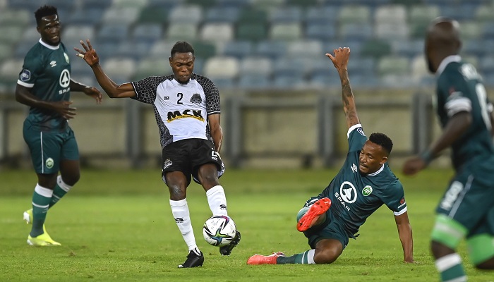 Lehlohonolo Majoro of Amazulu try's to defend an attack from Arsene Zola Kiaku of TP Mazembe FC