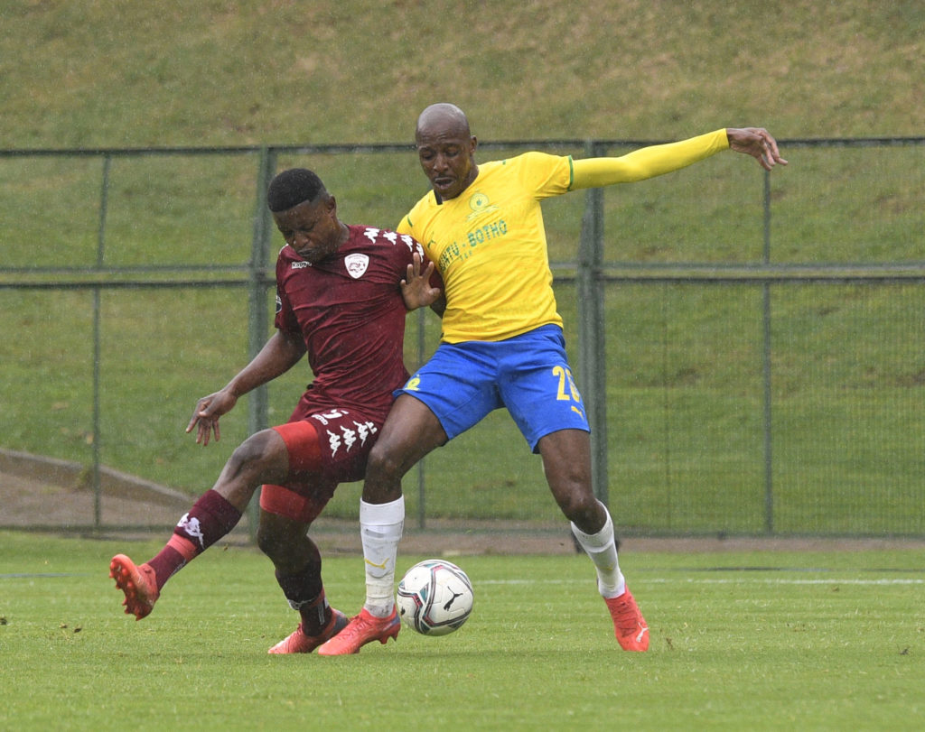 Khuliso Mudau of Mamelodi Sundowns challenges Nkanyiso Madonsela of Sekhukhune United FC