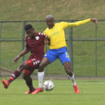 Khuliso Mudau of Mamelodi Sundowns challenges Nkanyiso Madonsela of Sekhukhune United FC