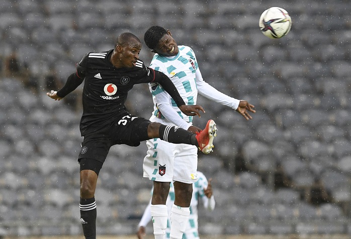 Bathusi Aubass of TS Galaxy challenges Terrence Dzukamanja of Orlando Pirates