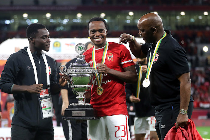 Percy Tau of Al Ahly celebrates with the CAF Super Cup trophy as Al Ahly coach Pitso Mosimane looks on during the 2021 CAF Super Cup match between Al Ahly and Raja Casablanca held at the Ahmed bin Ali Stadium in Al Rayyan, Qatar on 22 December 2021 ©Mohamed Bissar/BackpagePix