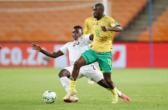 Bongokuhle Hlongwane of South Africa tackled by Farai Madhanaga of Zimbabwe during the 2022 World Cup Qualifier match between South Africa and Zimbabwe