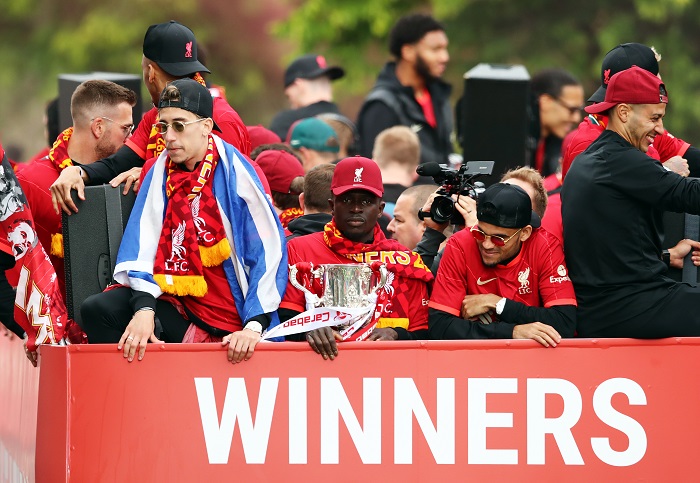 LIVERPOOL, ENGLAND - MAY 29: Sadio Mane of Liverpool holds the Carabao Cup Trophy alongside teammates during the Liverpool Trophy Parade on May 29, 2022 in Liverpool, England. (Photo by Jan Kruger/Getty Images)