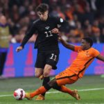 AMSTERDAM, NETHERLANDS - MARCH 29: Kai Havertz of Germany is challenged by Tyrell Malacia of Netherlands during the international friendly match between Netherlands and Germany at Johan Cruijff Arena on March 29, 2022 in Amsterdam, Netherlands. (Photo by Alex Grimm/Getty Images)