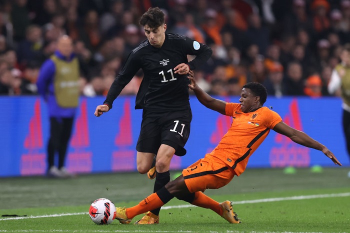 AMSTERDAM, NETHERLANDS - MARCH 29: Kai Havertz of Germany is challenged by Tyrell Malacia of Netherlands during the international friendly match between Netherlands and Germany at Johan Cruijff Arena on March 29, 2022 in Amsterdam, Netherlands. (Photo by Alex Grimm/Getty Images)