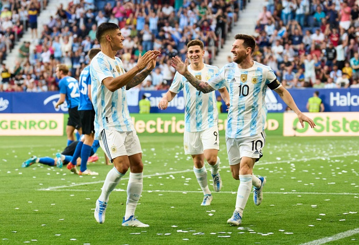 Lionel Messi of Argentina celebrates with his teammates Carlos Joaquin Correa of Argentina after scoring his team's third goal during the international friendly match between Argentina and Estonia at Estadio El Sadar on June 05, 2022 in Pamplona, Spain. (Photo by Juan Manuel Serrano Arce/Getty Images)