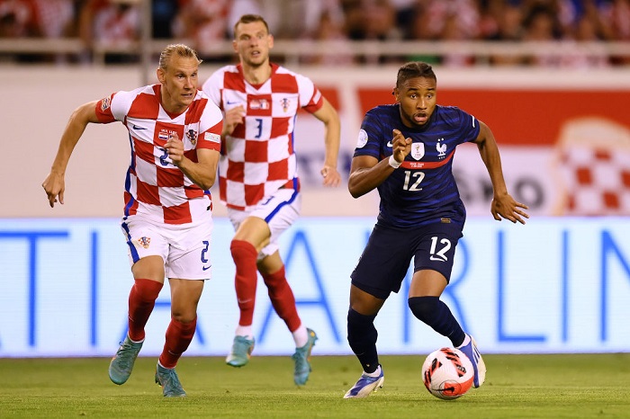 Christopher Nkunku of France runs with the ball whilst under pressure from Domagoj Vida of Croatia during the UEFA Nations League League A Group 1 match between Croatia and France at Stadion Poljud on June 06, 2022 in Split, Croatia. (Photo by Jurij Kodrun/Getty Images)