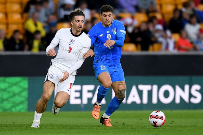 WOLVERHAMPTON, ENGLAND - JUNE 11: Jack Grealish of England battles for possession with Giovanni Di Lorenzo of Italy during the UEFA Nations League - League A Group 3 match between England and Italy at Molineux on June 11, 2022 in Wolverhampton, England. This game will be played behind closed doors following on from the Euro 2020 final. (Photo by Claudio Villa/Getty Images)