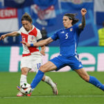 Croatia's Luka Modric challenged by Italy's Riccardo