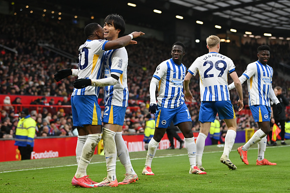 MANCHESTER, ENGLAND - JANUARY 19: Kaoru Mitoma of Brighton & Hove Albion celebrates scoring his team's second goal with teammate Pervis Estupinan during the Premier League match between Manchester United FC and Brighton & Hove Albion FC at Old Trafford on January 19, 2025 in Manchester, England.